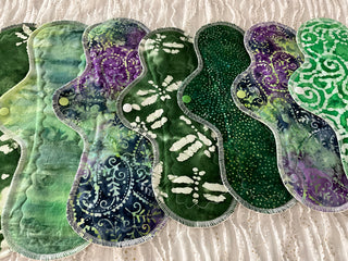 Set of green and purple patterned pads on a textured surface
